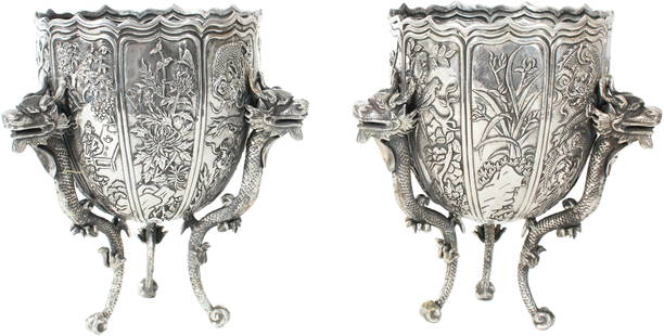 Pr Chinese Export Silver Dragon Vases 25 OZT: Pair of Chinese export Silver footed vases marked Lee Ching with figures, Japanese cherry blossom, and dragon motif handles.Size: 6 x 6 x 7 1/2 in.