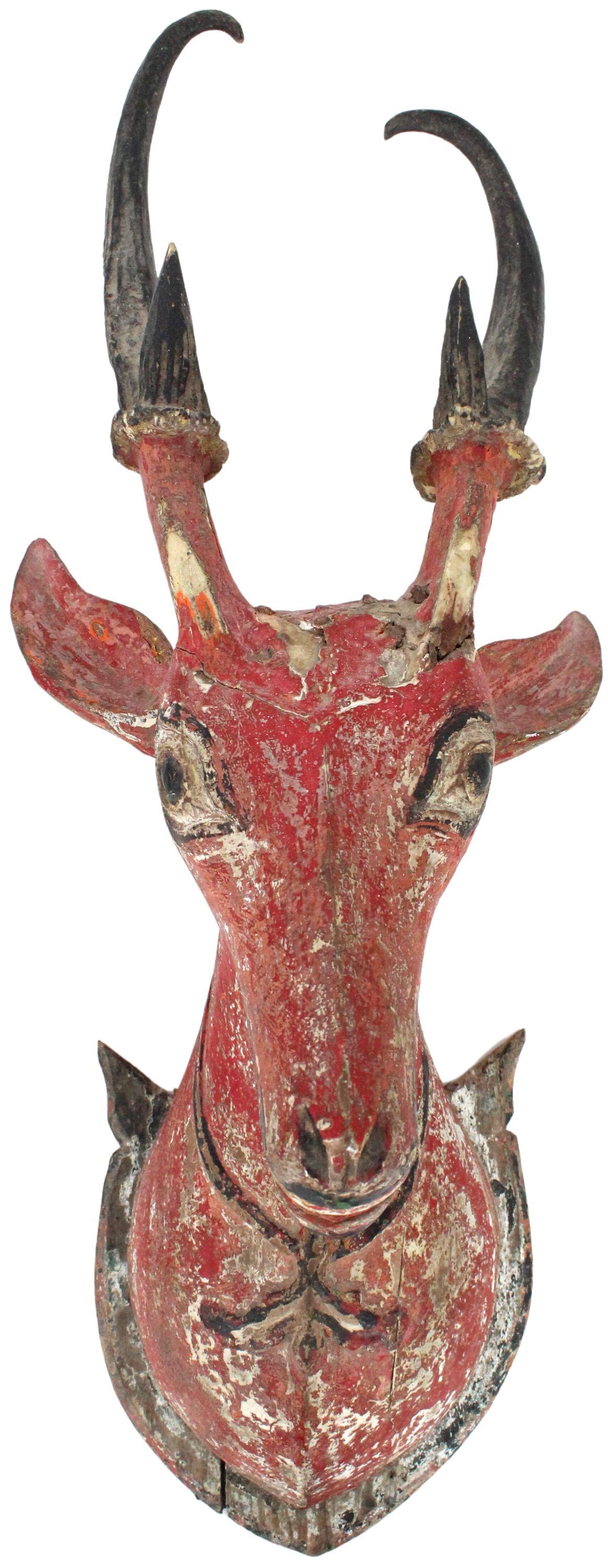 Carved Primitive Deer Head, Wood, As Is: Carved Primitive Deer Head, Painted Wood, As Is. The piece is able to be hung, it has signs of fractures and chipping on the paint & the wood. Size: 8 1/2 x 10 x 22 in. #2303