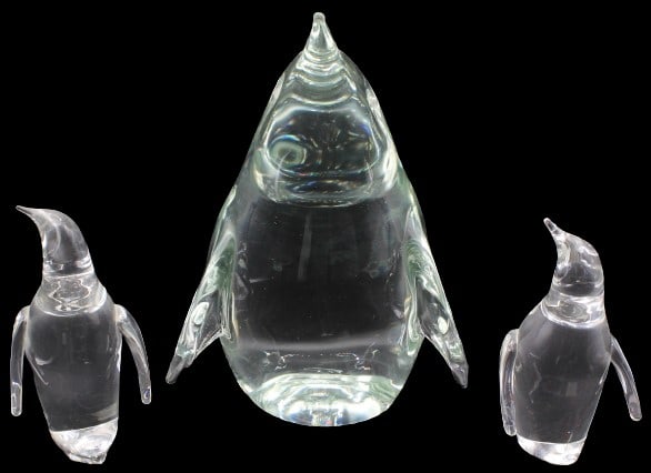 Group of (3) Glass Penguins, 2 Steuben 1 Signed: Group of (3) Glass Penguins, 2 Steuben 1 Signed. The 2 smaller are Steuben. Marked on underside. Steuben (American), third quarter 20th century. Group of three George Thompson colorless crystal pengui