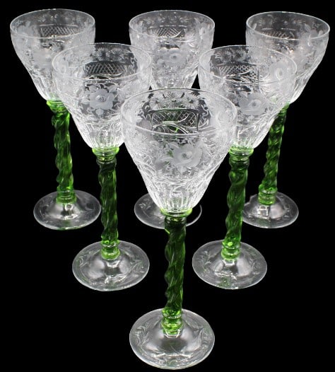 (6) Impressive Green Stemmed Etched Goblets: (6) Impressive, richly etched wine goblets with twisted green stems and clear, etched round bases with leaf design. One stem is signed indistinctly on underside. Size: 3 3/4 x 3 3/4 x 10 1/8 in. #1137