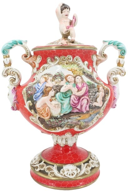 Large Capodimonte Porcelain Vase with Cherub Lid: Large Capodimonte Porcelain Vase with Cherub Lid. Slight loss to one of the cherubs toes (see image 10). Marked Capodimonte Italy with crown on the underside. Size: 16 x 10 x 21 1/2 in.