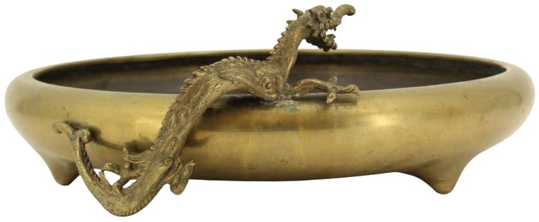 Japanese Bronze Dragon Bowl: Shallow Japanese bronze bowl standing on three short feet, with bronze dragon sculpture attached to side, crawling over edge of bowl.Condition: Dragon falling off. Size: 15 5/8 x 16 1/2 x 5 1/2 in. #1
