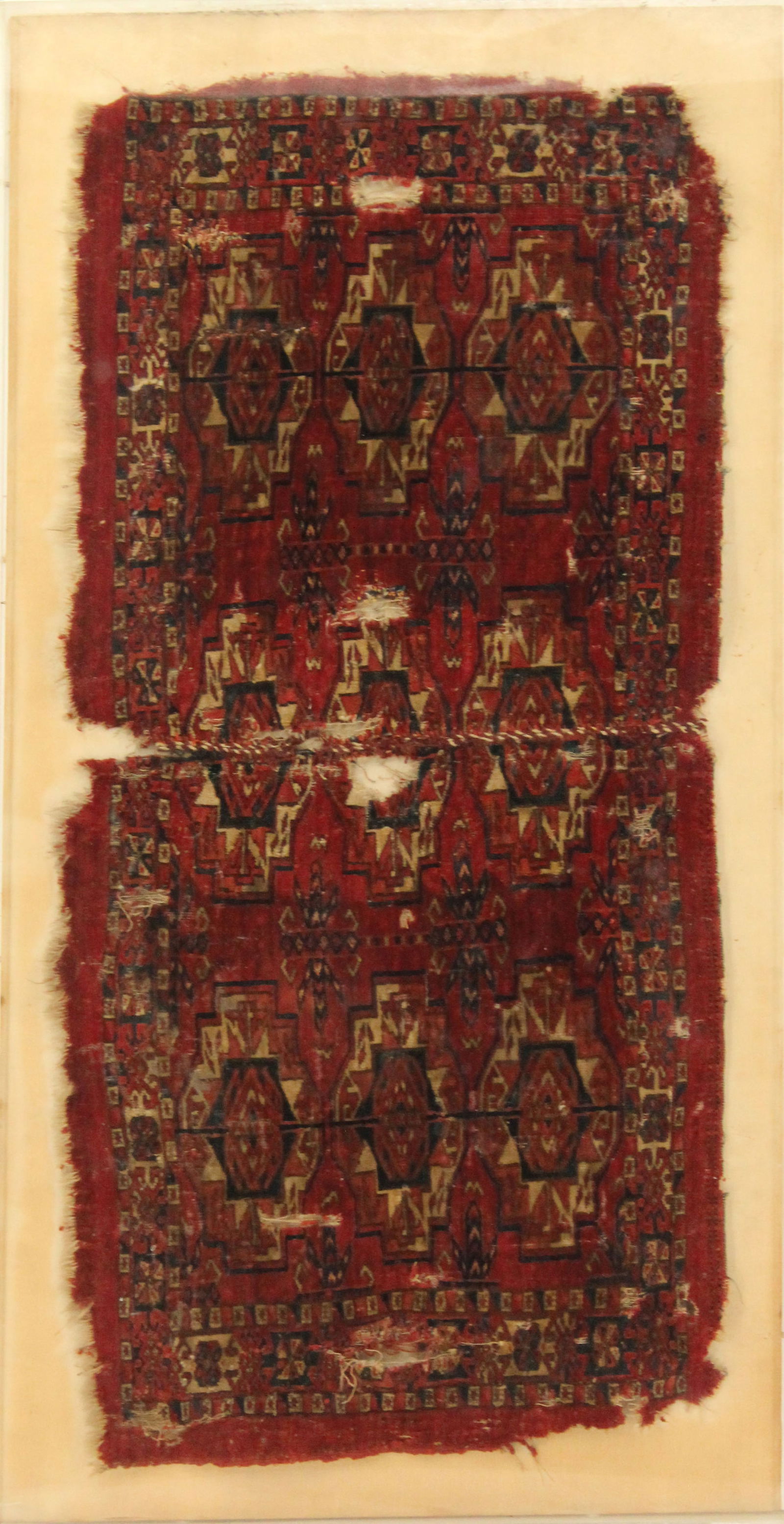 Framed Antique Bokhara / Turkoman Saddle Rug: Antique Bokhara / Turkoman Saddle Rug. Housed in a Lucite Shadow Box. Overall Size: 42 x 22 in. Sight Size: 38 1/2 x 19 1/2 in. Thickness: 2 in. #2234 Location BA