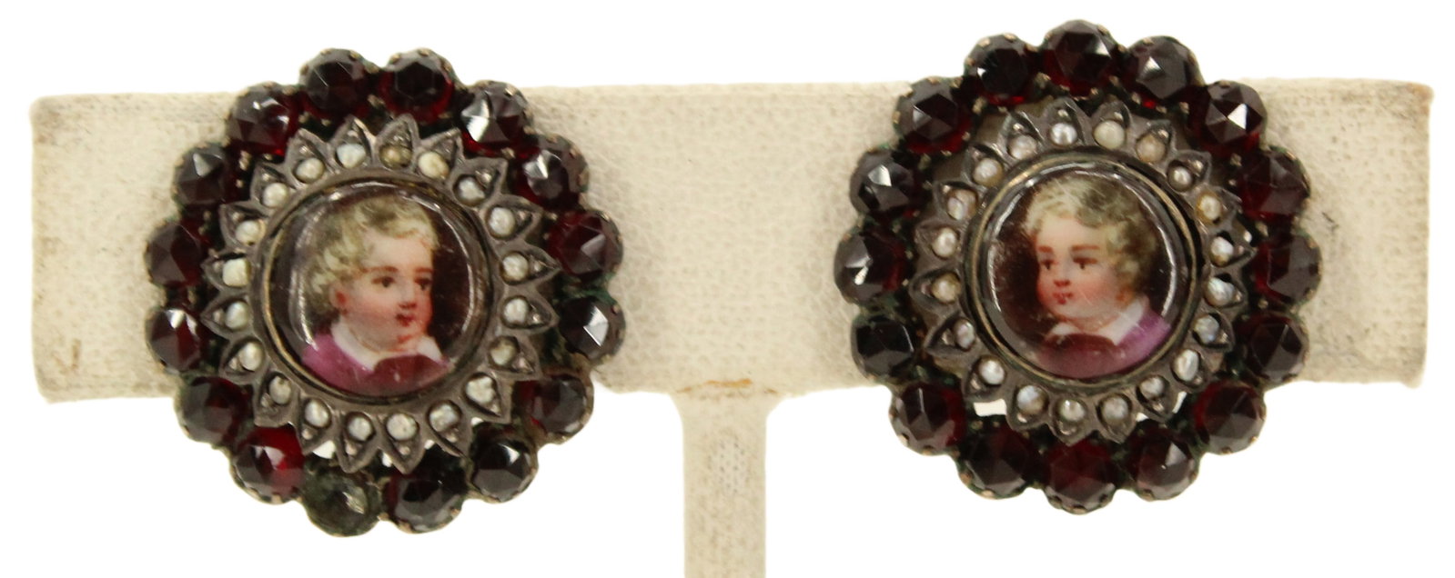 Pair of Painted Porcelain 10k Tested & Garnet Earrings - 8.5 g.: Pair of Painted Porcelain 10k Tested & Garnet Earrings. Clip ons. Painted portrait on each earring, each with a portrait of a young child. 16 round cut garnets on outer border of each e