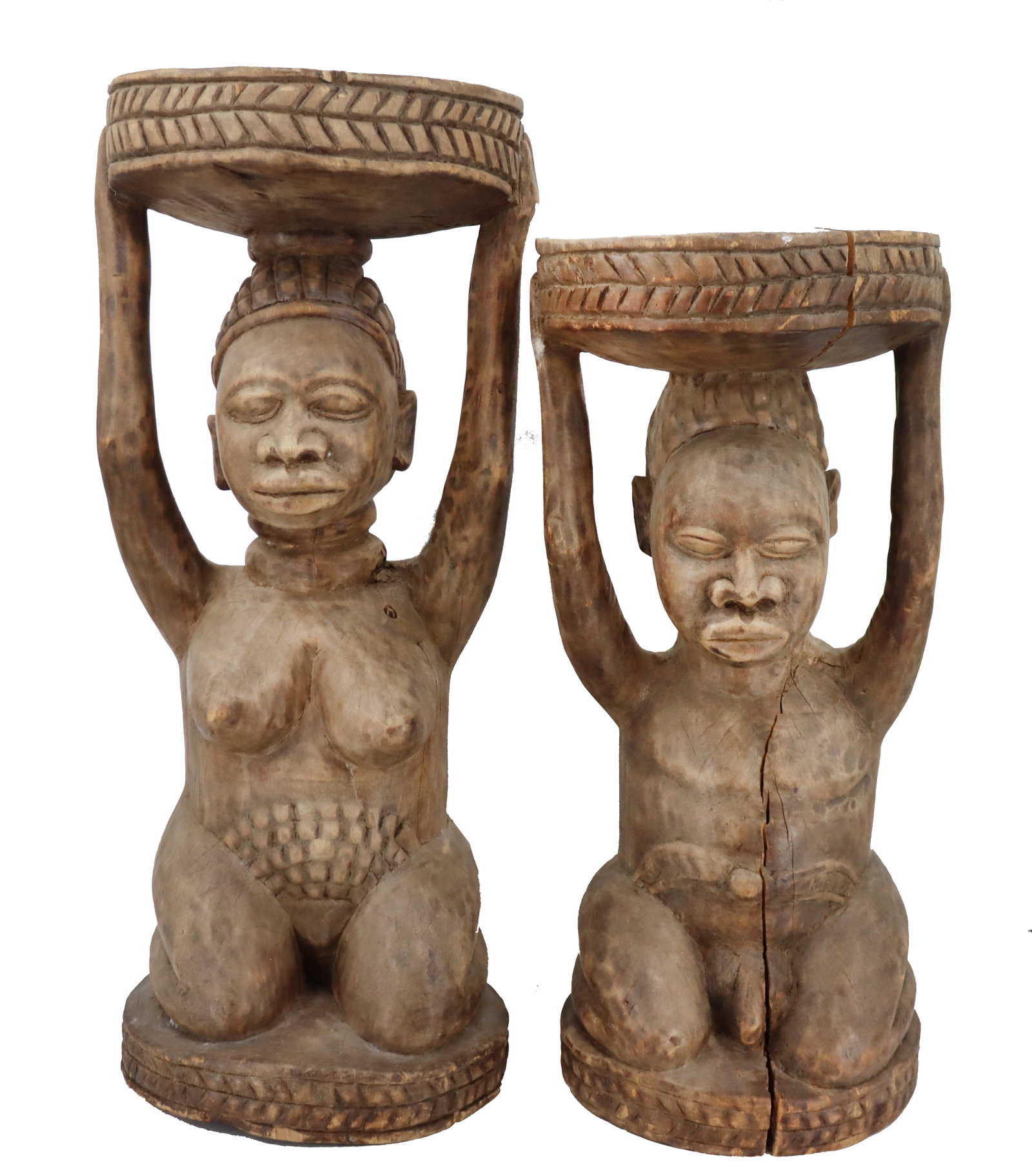 Two African Carved Wood Figural Stools: Two African Carved Wood Figural Stools. Each depicts a nude male or nude female, with hands raised, supporting a circular seat. Size: 14 1/2 x 14 1/2 x 35 1/2 in. #8123 