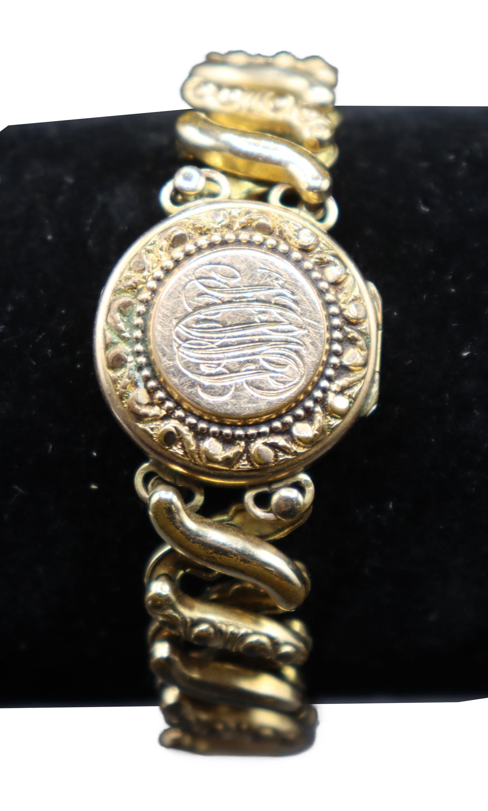 Ladies Locket Bracelet: Ladies Locket Bracelet Base metal and has a gold layer. Personal engraving on the front of the locket. Stretches. Size: 4 in, #8261 
