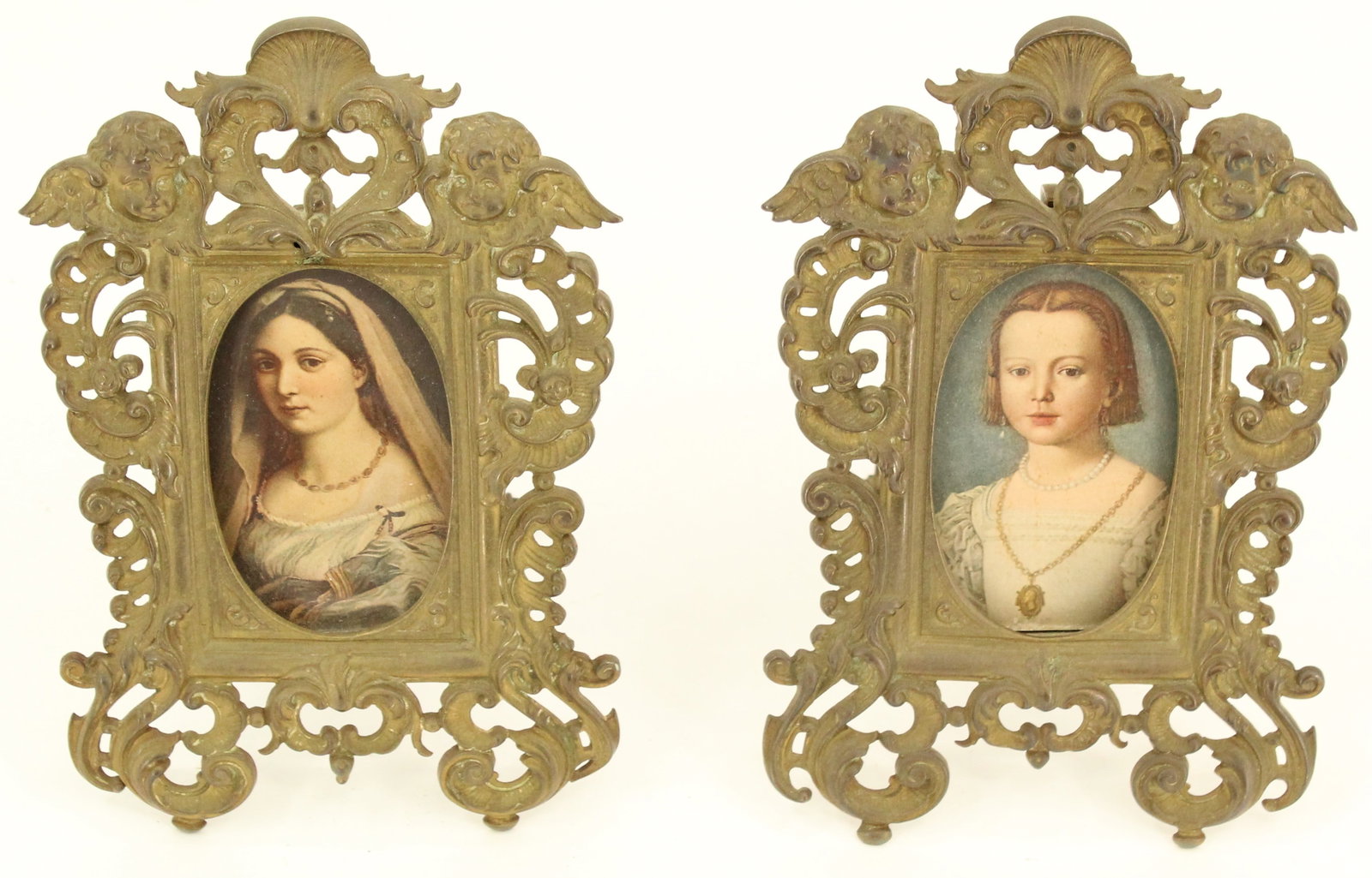 Pair of Antique Miniature Brass Picture Frames with Cherub Decoration: Pair of Antique Miniature Brass Picture Frames with Cherub Decoration. Ornate frames from the 19th Century with oval openings. Overall: (each) 7 1/2 X 4 3/4 in. Sight: (each) 3 1/2 X 2 in.