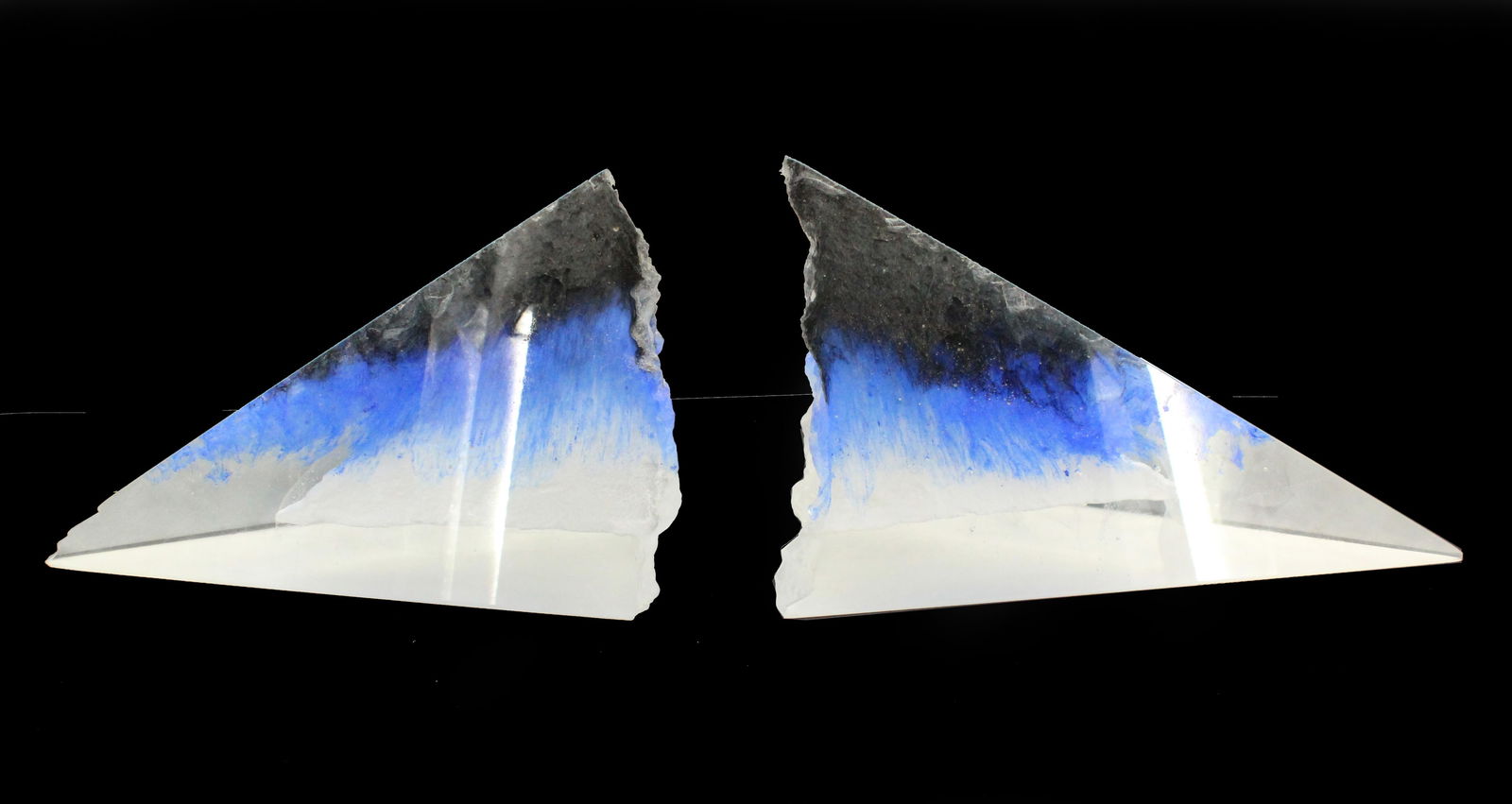 (2) Colin Reid (Born 1953) American, Untitled Glass Pyramids: (2) Colin Reid (American, b. 1953) Untitled Glass Pyramids. Sculpture created to look like a broken icicle style geode with jagged finished edge to one sculpture. Likely polished out edge on left scul
