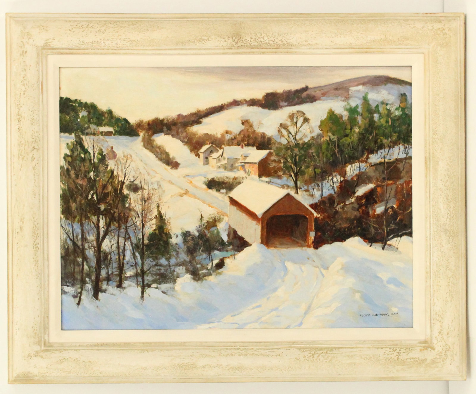 Floyd Gahman (1894-1979) American, Oil on Board Landscape: Floyd Gahman (American, 1894-1979) Oil on Board Landscape. A winter landscape scene depicting a small town in the snowy mountains. Signed lower right. Framed. Overall Size: 24 3/4 x 30 1/2 in. Sight S