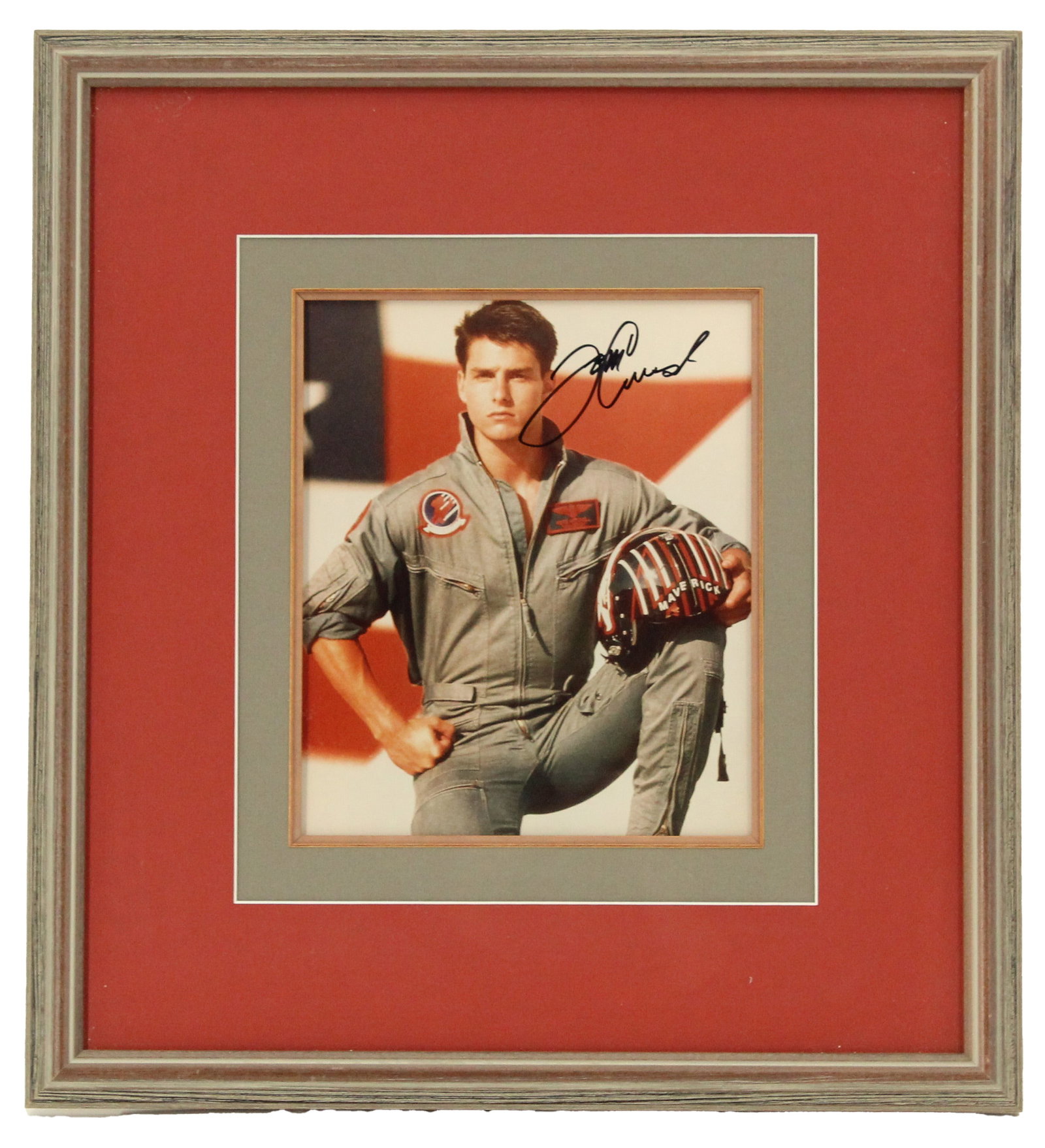 Tom Cruise (Born 1962) American, Autographed and Framed Photo: Tom Cruise (Born 1962) American, Autographed and Framed Photo. Shows him in his iconic Maverick flight suit from the film Top Gun, including the helmet with a large flag in the background. Autographed