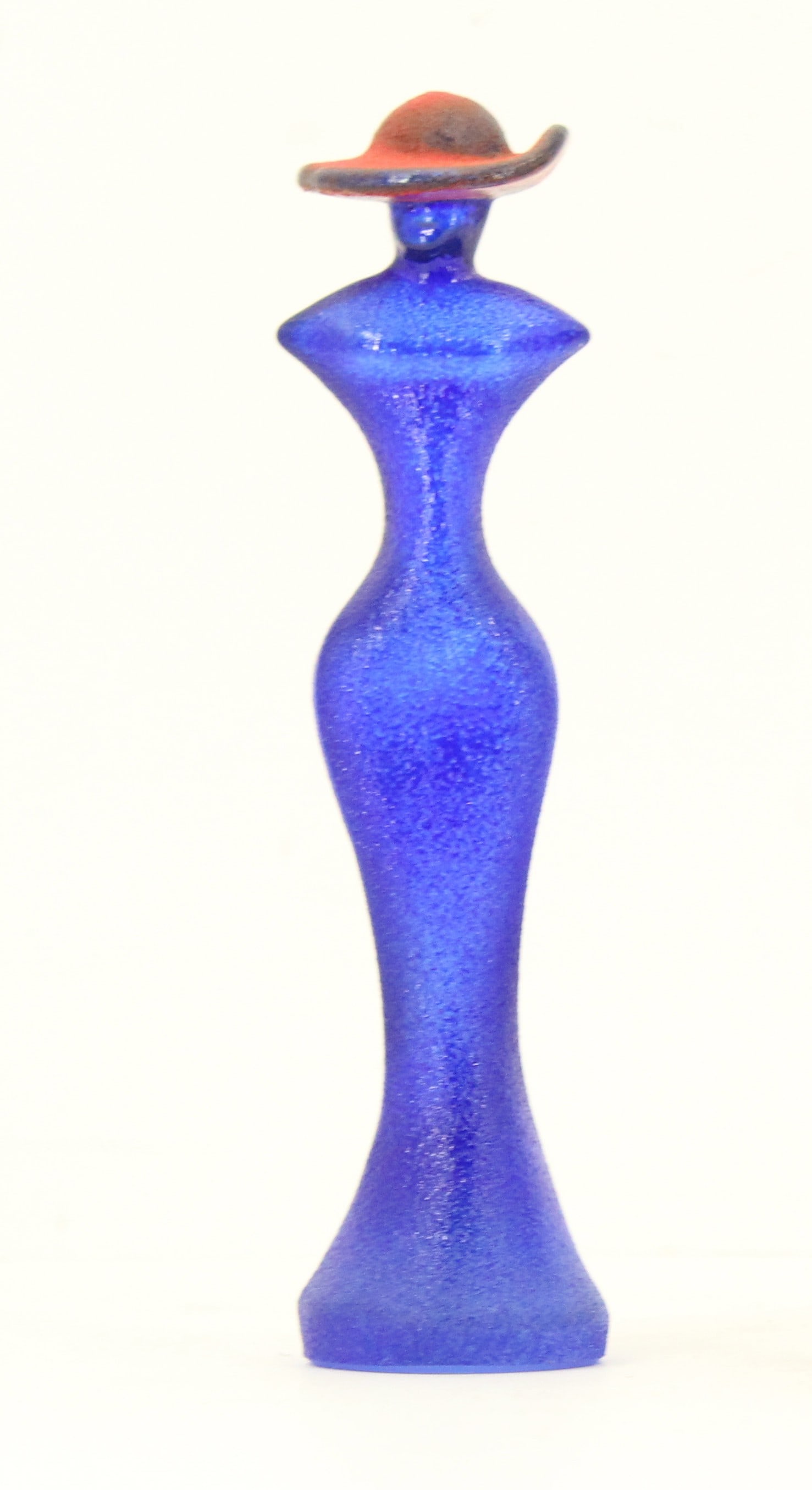 Signed Kosta Boda Glass Statuette: Signed Kosta Boda Glass Statuette. Blue with defined curves and a reddish hat. Signed and numbered on the base by Swedish glass artist Kjell Engman (Born 1946)