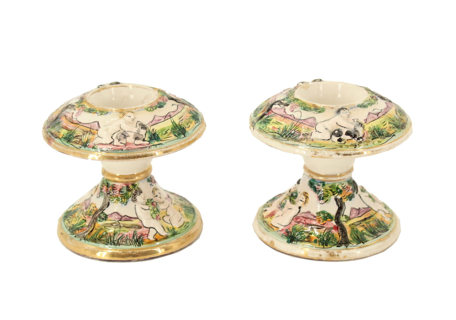 (2) Capodimonte Porcelain Candle Holders: (2) Capodimonte Porcelain Candle Holders. Marked on underside. Round, slightly flared base. Stem is short and bulbous. Top has a wide, flared, mushroom like cap. Hand-painted scenes with figural