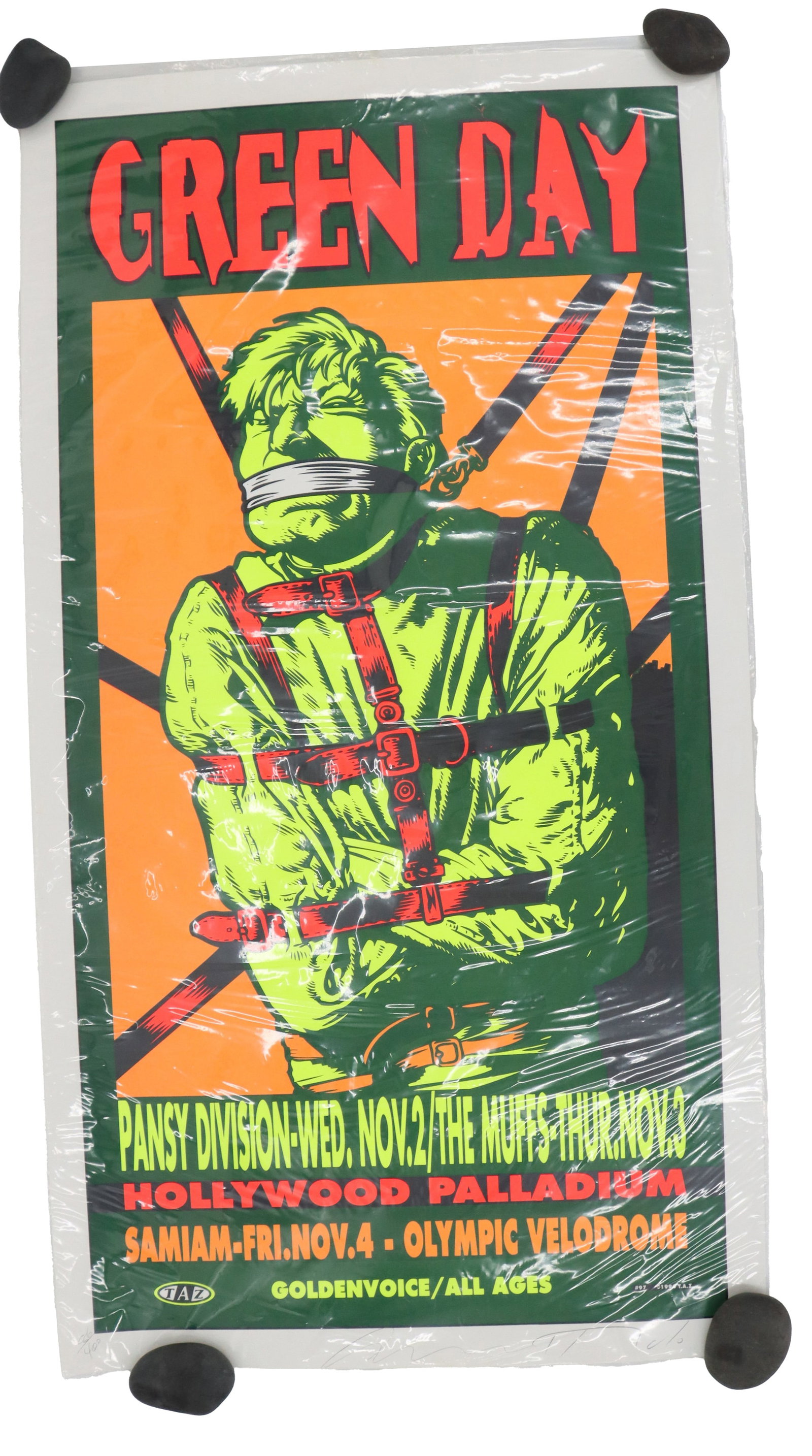 Jim Evans/TAZ (Born 1950s) American, Signed and Numbered Green Day 1994 Concert Poster: Jim Evans/TAZ (Born 1950s) American, Signed and Numbered Green Day 1994 Concert Poster. Lithographic print depicts a pulp-inspired image of a green-hued man struggling against a straight jacket, with