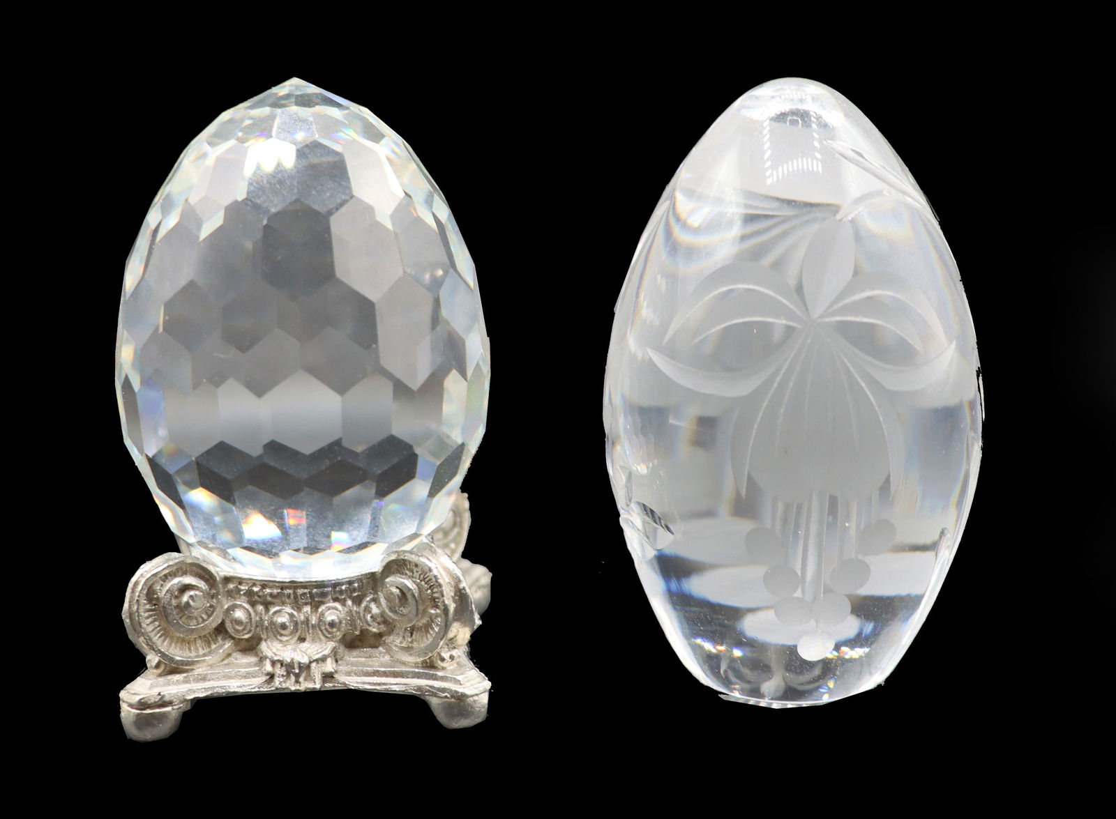 (2) Swarovski and Royal Brierley Crystal Paperweights with Metal Stand: (2) Swarovski and Royal Brierley Crystal Paperweights with Metal Stand. Swarovski is covered in geometric honeycomb pattern, and the Royal Brierly shows a cameo pattern on one side and a clear reed-li