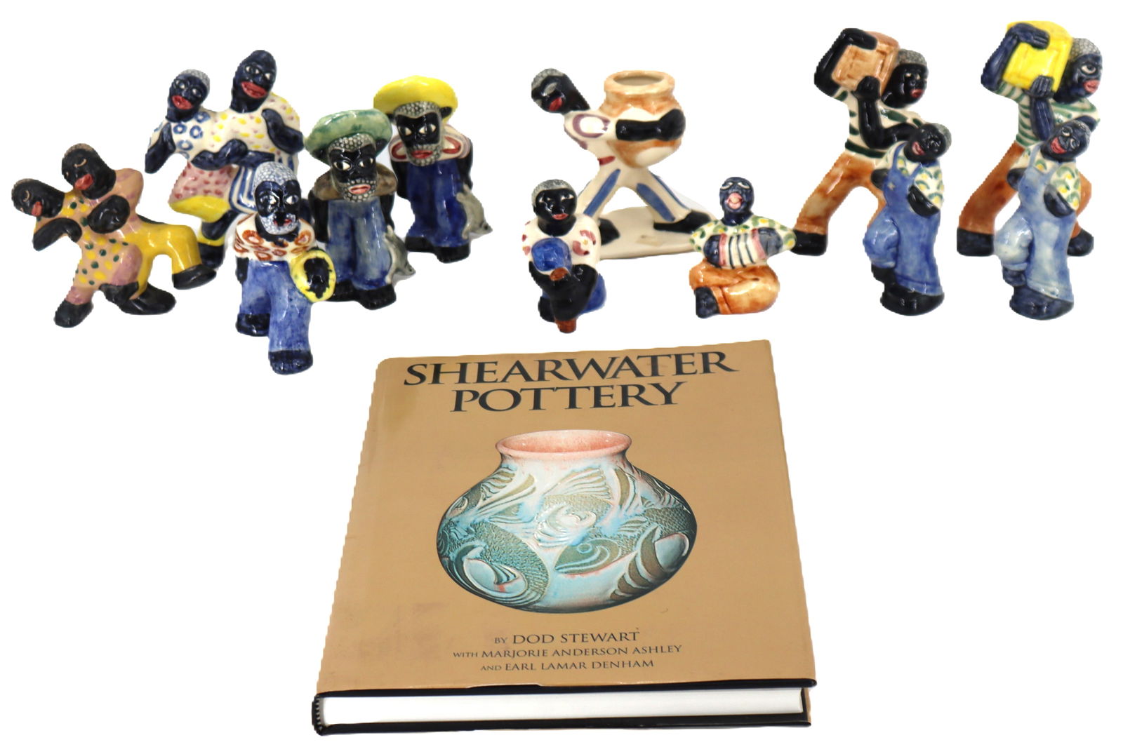 Lot of 12 Black Americana Figurines from Shearwater Pottery Along With Book: Lot of 12 Black Americana Figurines from Shearwater Pottery Along With Book. Many of these delicately painted pieces are difficult to find now and are sought after by collectors, and the hardcover boo