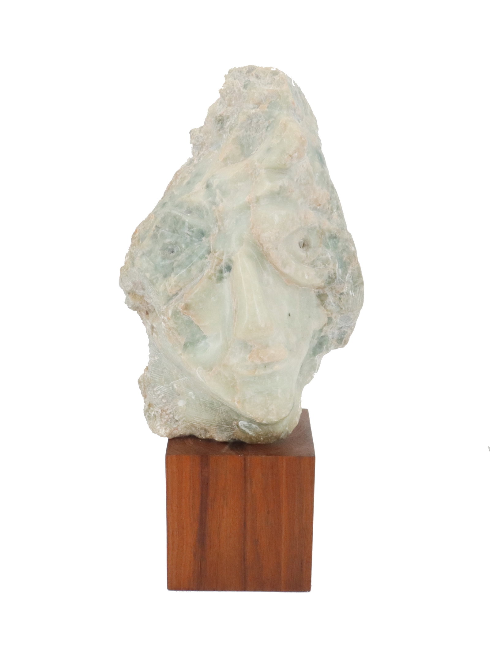 Carved Stone Sculpture In Form Of A Woman's Face: Carved Stone Sculpture In Form Of A Woman's Face. Likely Limestone. It looks like the artist followed some of the natural shape of the stone to create the design as some of the dimensions ar