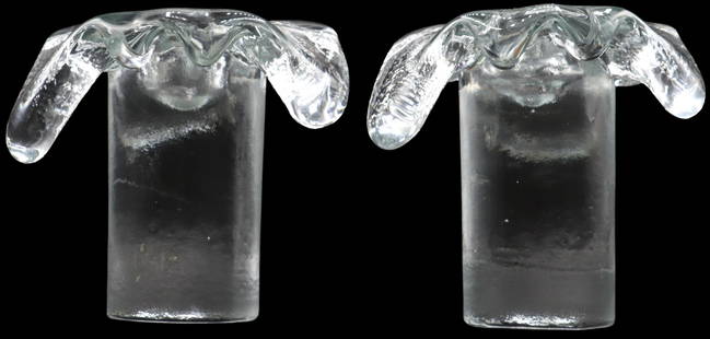Pair of American Blenko Mid Century Art Glass Candleholders: Pair of American Blenko Mid Century Art Glass Candleholders. Unique design like a fired bullet that has smashed open on impact, with opaque sides. Plastic labels on the tops of both that read "Bl