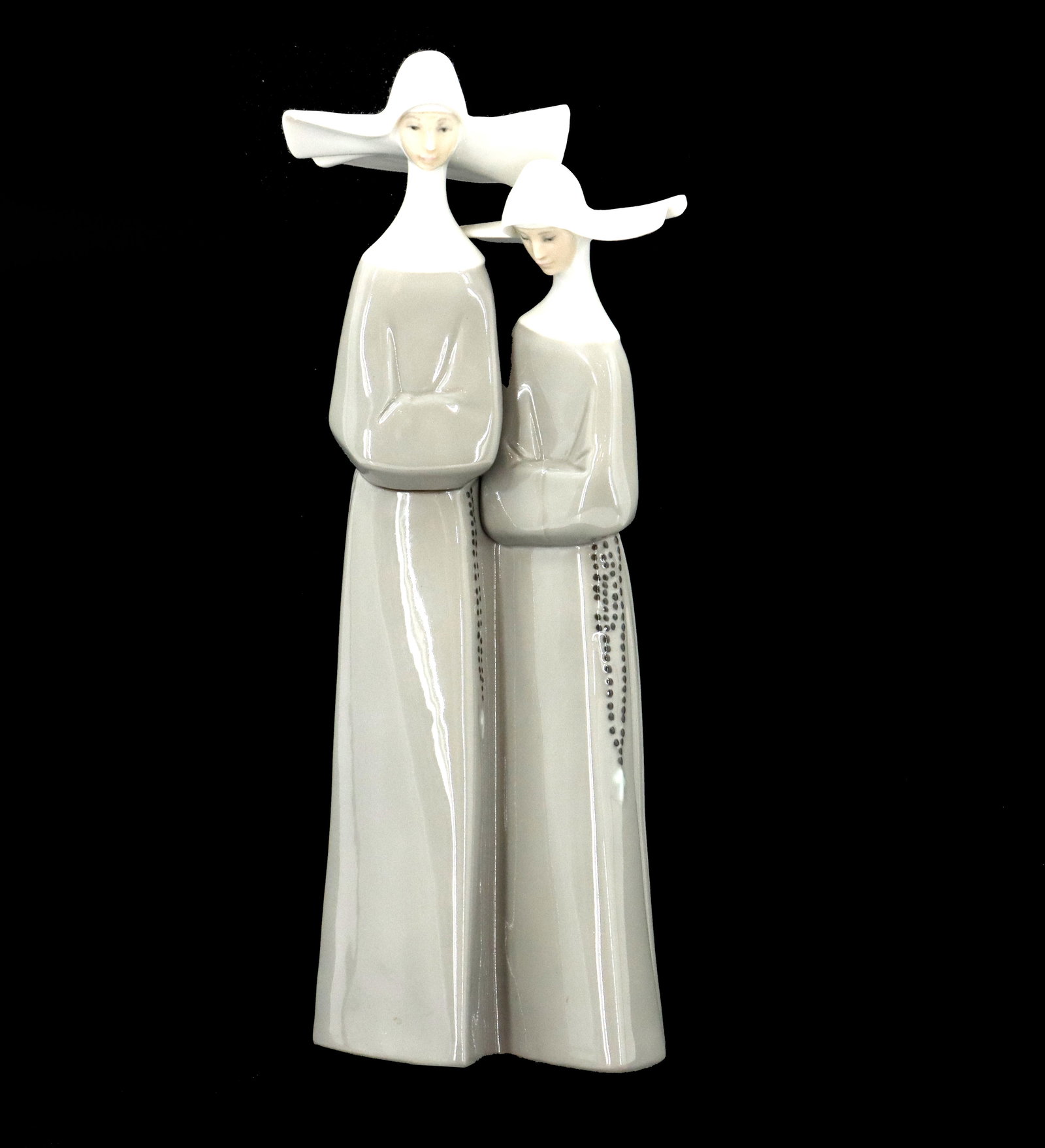 Lladro Porcelain Nuns: Lladro Porcelain Nuns. Lladro porcelain figurine depicting a pair of nuns with rosaries. Glossy finish. Condition: Good. Size: 13 1/2 x 5 1/2 x 4 1/2 in. Lladro porcelain is a