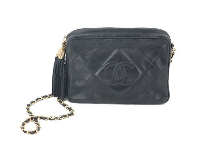 Chanel Black Clutch: Chanel Black Clutch. Quilted leather. Features a prominent interlocking "CC" logo embossed on the front, centered within the quilting. Gold toned chain strap interwoven with black leat