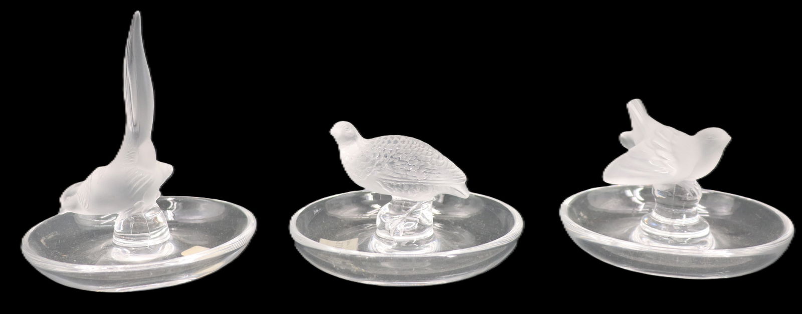 (3) French Lalique Crystal Bird Ring Holders: (3) French Lalique Crystal Bird Ring Holders. Each is a different bird, in a different pose. Marked on bases, one with original label. Condition: Overall great. Largest Size: 3 1/2 x