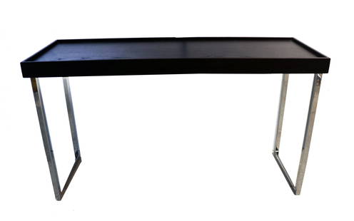 Modern Chrome and Black Wood-Look Low Table or Bench: This sleek, contemporary low table or bench features a minimalist design with a rectangular black wood-like top framed by subtle raised edges. Its clean-lined chrome-plated metal legs form a geometric