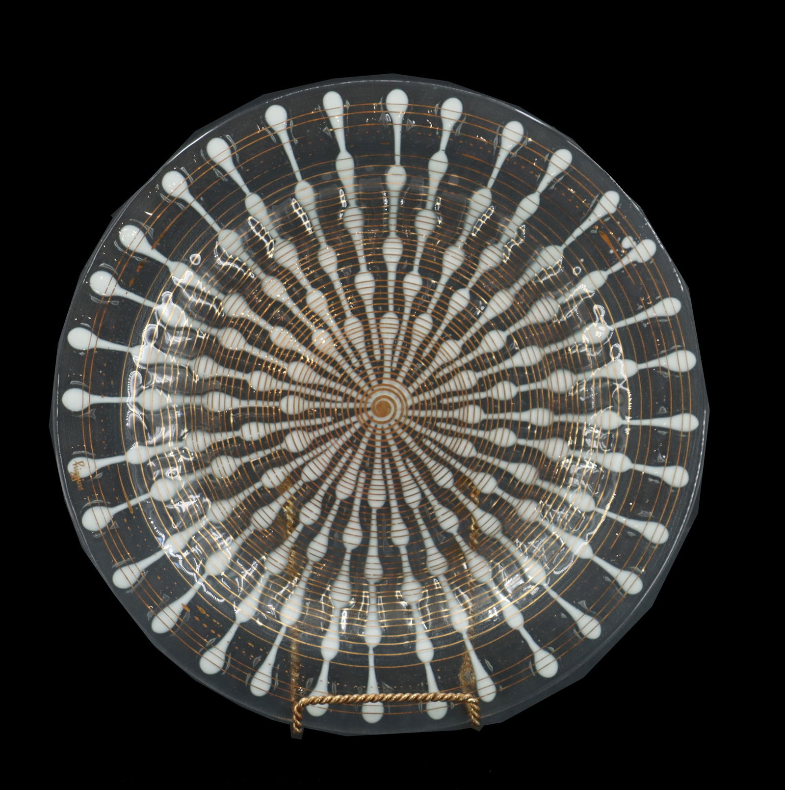 Higgins Glass Studio Decorative Fused Glass Plate: Higgins Glass Studio Decorative Fused Glass Plate. Milky sunburst pattern from the center of the clear plate, with a spiraling golden hued line throughout. At the end of the spiral is the name Hi