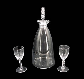 French Lalique Crystal Geubwiller Pattern Decanter and (2) Cordial Glasses: French Lalique Crystal Geubwiller Pattern Decanter and (2) Cordial Glasses. The style, which utilizes a Celtic knot in the stem of the glasses and the stopper of the decanter, first debuted in 1926 an