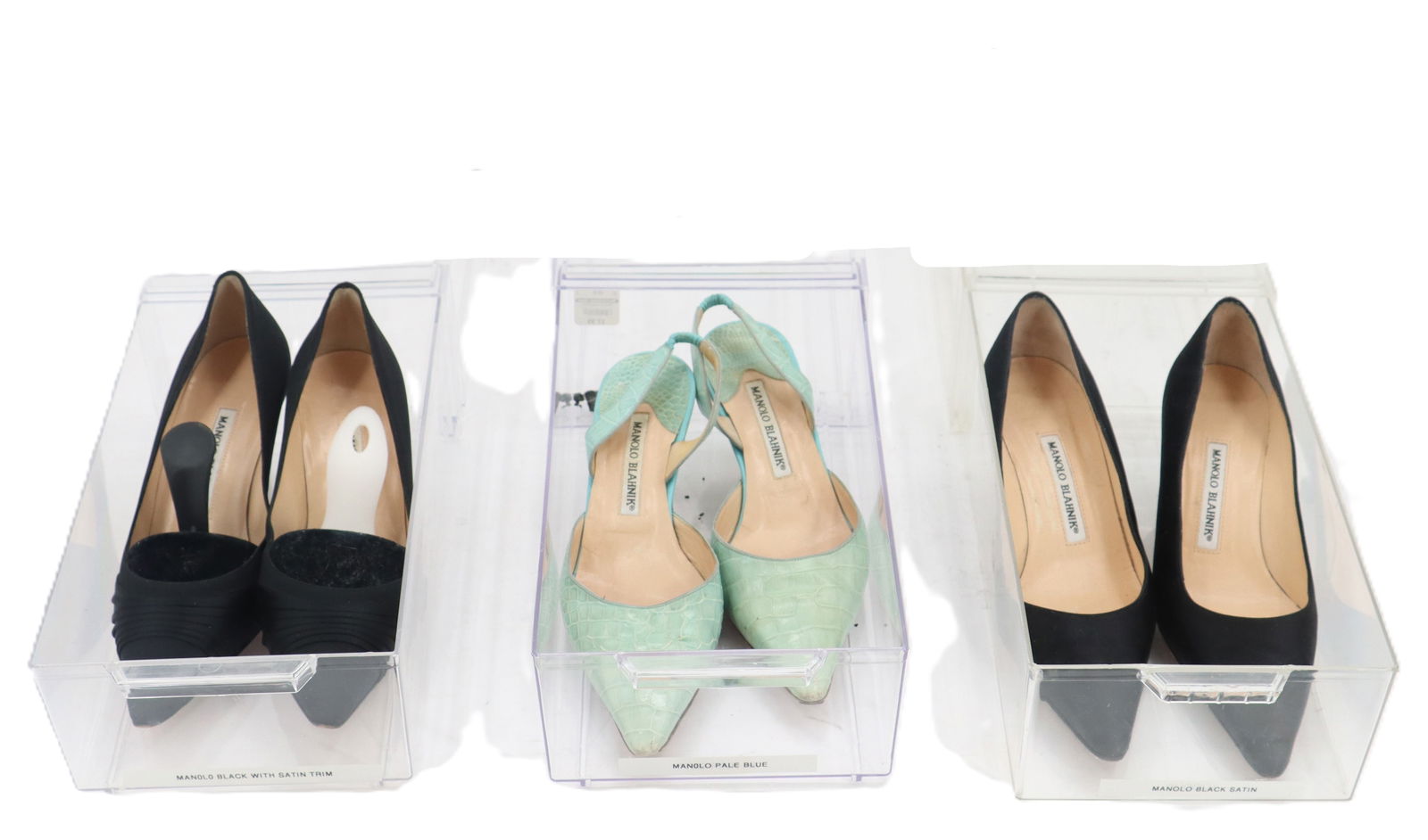 (3) Pairs of Manolo Blahnik Heels: (3) Pairs of Manolo Blahnik Heels. Classic black satin pointed toe heels. Kitten heel. Tan soles. European size 37 - US size 6.5. Pale blue pointed toe sling back heels. Kitten heel. Tan s