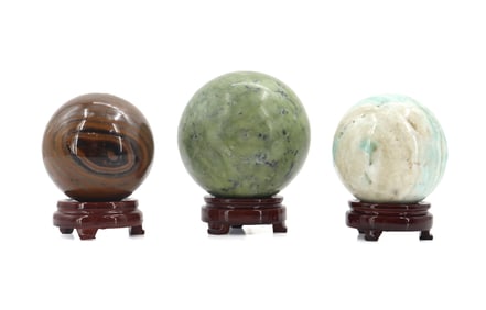 Group of 3 Polished Stone Spheres on Wooden Stands