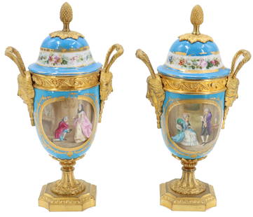Exceptional Pair of Late 19th Early 20th Century French Sevres Porcelain and Gilt Bronze Covered: Exceptional Pair of Late 19th Early 20th Century French Sevres Porcelain and Gilt Bronze Covered Urns. Detailed dore bronze gilt face mask handles terminating in a high gilt bronze Louis style foot. G