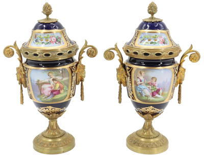 Pair of Late 19th Early 20th Century French Sevres Style Porcelain and Gilt Bronze Covered Urns: Pair of Late 19th Early 20th Century French Sevres Style Porcelain and Gilt Bronze Covered Urns. Lovely rare handles with ram head masks. Figural scenes on either side depicting a woman and a man sitt