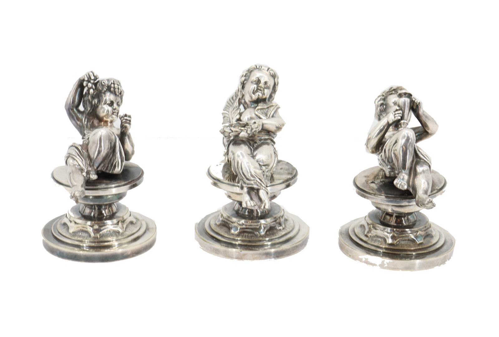 (3) Silvered Metal Putti Figures: (3) Silvered Metal Putti Figures. Lot comprised of three small silvered mixed metal putti or cherub figures in traditional togas; one eating grapes, one with plate of food, one with wine flask. Attach