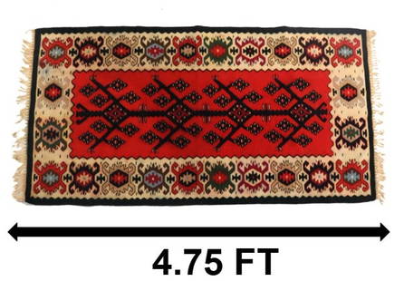 Turkish Kilim Wool Rug: Turkish Kilim Wool Rug. Distinct floral tree pattern in the sharp red middle field with repeating eye patterns in the wide cream-based border.&nbsp; Condition: Very good.&nbsp; Size: 28 x 57 in.&nbsp;