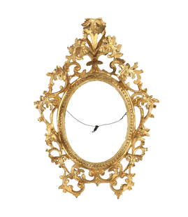 Carved Gilt Wood Wall Hung Oval Picture Frame: Carved Gilt Wood Wall Hung Oval Picture Frame. Ornately carved wall hung ovoid picture frame with twisting leaves and folage, with gilt overlay. Ornately carved wood picture frames are decorative and