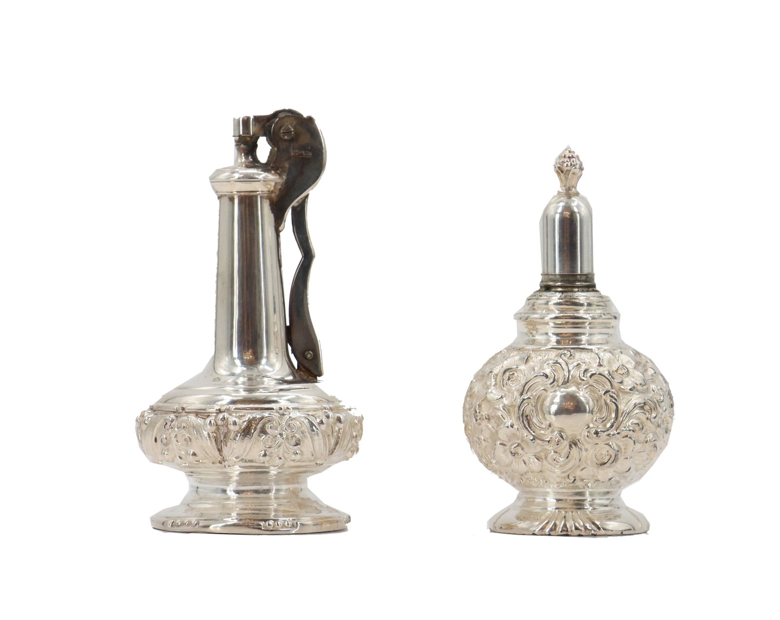 (2) .799 Silver Alloy Decanters: (2) .799 Silver Alloy Decanters. Lot comprised of two silver decanters by different manufacturers, with foliate designs in shallow raised relief. Size: 2 1/2 x 2 1/2 x 4 1/2 in. Oil decanters a