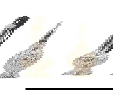 (2) .799 Silver Alloy Decanters: (2) .799 Silver Alloy Decanters. Lot comprised of two silver decanters by different manufacturers, with foliate designs in shallow raised relief. Size: 2 1/2 x 2 1/2 x 4 1/2 in. &nbsp; Oil decanters a