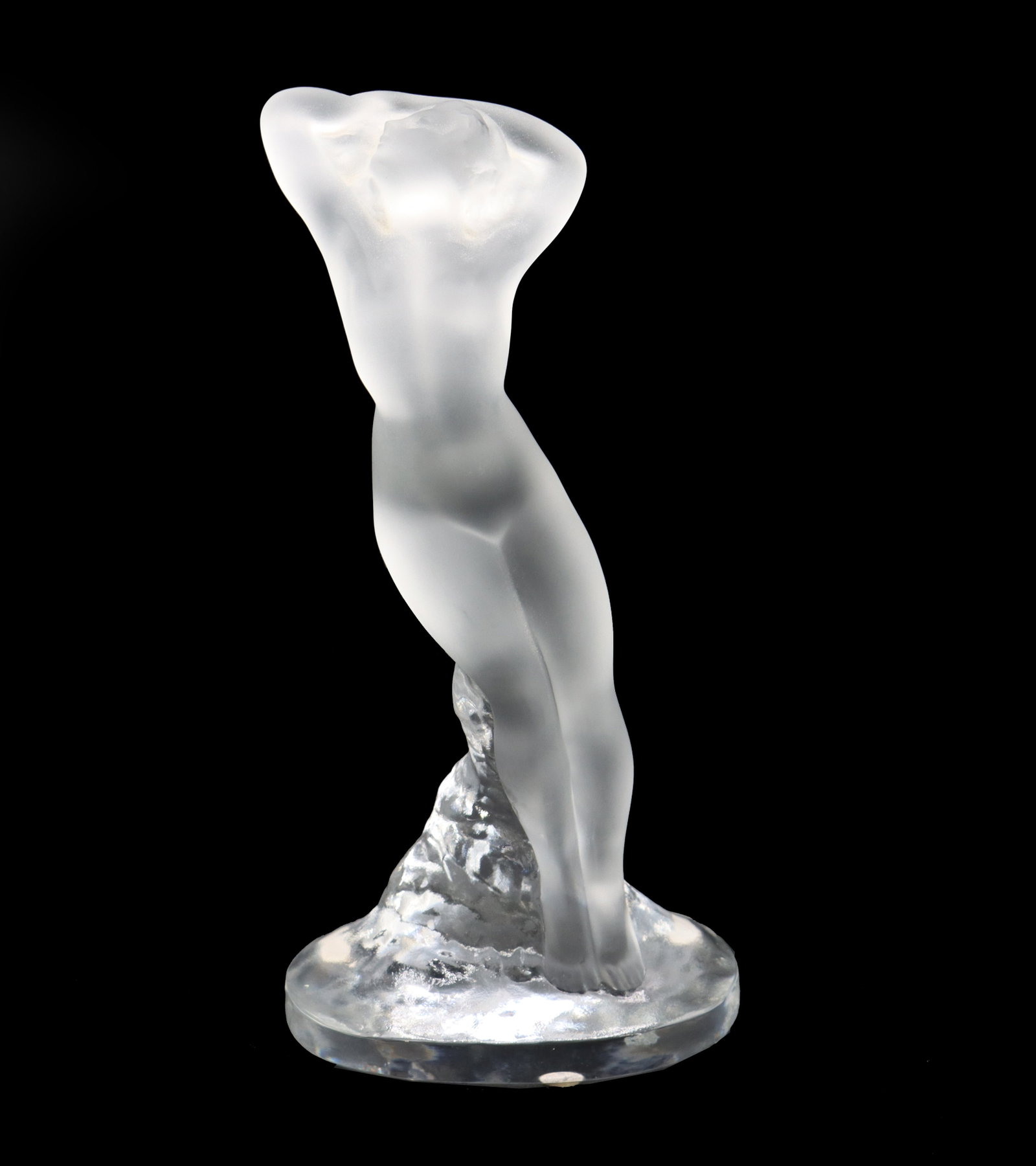 French Lalique Crystal "Danseuse Bras Leves" Frosted and Opaque Female Nude Statue: French Lalique Crystal "Danseuse Bras Leves" Frosted and Opaque Female Nude Statue. Delicate curves and lines lead to a round flat base, where the piece is signed on the side. Con