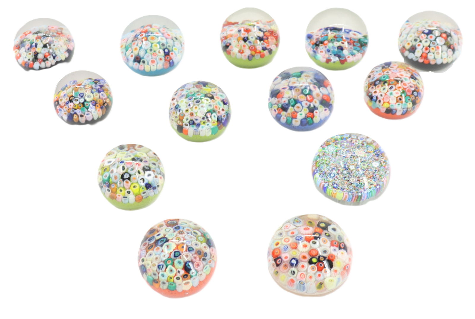 (13) Millefiori Art Glass Paperweights: (13) Millefiori Art Glass Paperweights. A variety of shapes and colors, some with labels affixed to the bottoms with prior pricing and identification numbers. Largest Size: 3 x 3 x 2 i