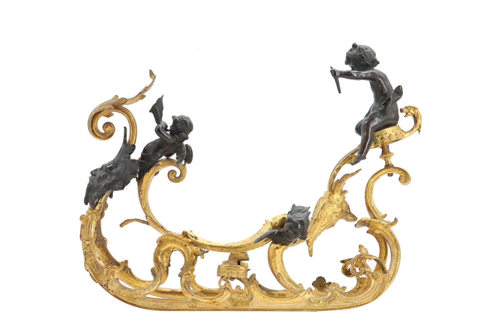 Gilt Bronze Cherub Sleigh Centerpiece Frame: Gilt Bronze Cherub Sleigh Centerpiece Frame. Cherub sleigh centerpiece frame featuring a gilt bronze foliate and scroll frame with black metal riding cherubs. Believed to have had a porcelain shoe-sha