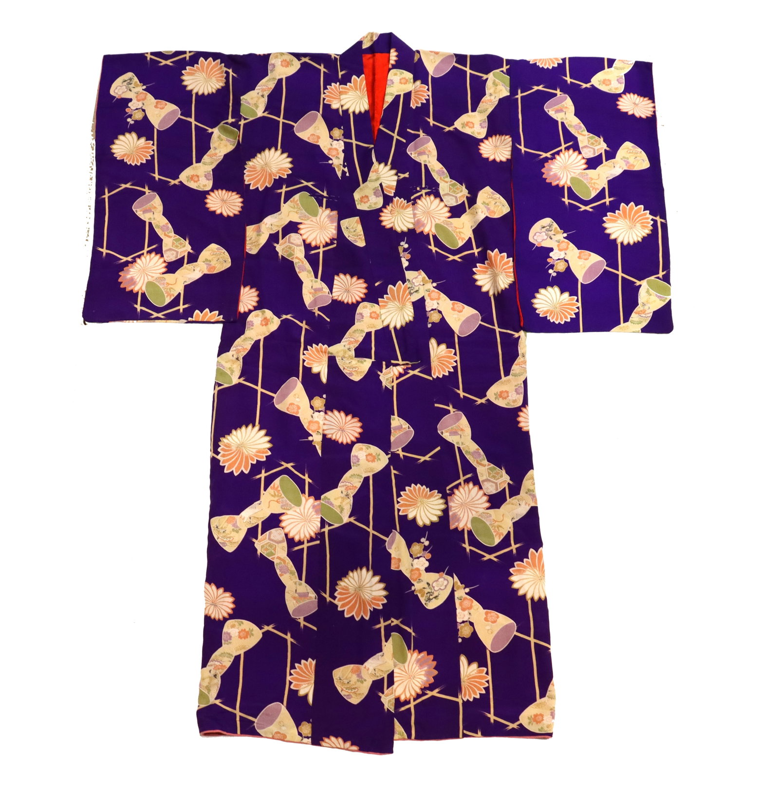 Japanese Purple Silk Kimono: Japanese Purple Silk Kimono. Covered in bow, flower, and abstract trapezoidal designs. Red interior. Size: 48 x 61 in. The kimono (literally "thing to wear") is the traditional J