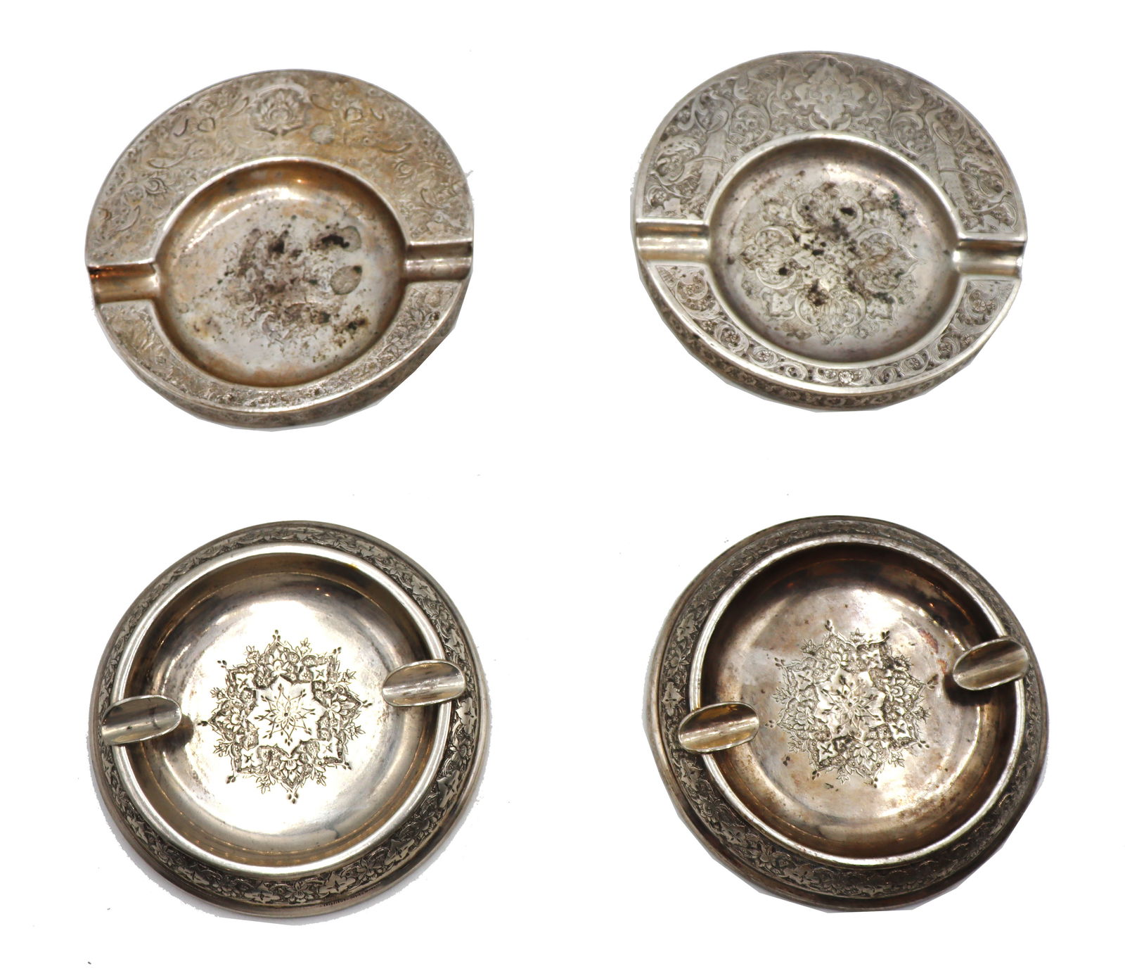 (4) Persian Silver Ash Trays - 12.870 ozt.: (4) Persian Silver Ash Trays - 12.870 ozt. Two matching pairs. Marked on undersides. Larger Trays: 4 1/2 in. Smaller Trays: 4 in. Weight: 12.870 ozt. 