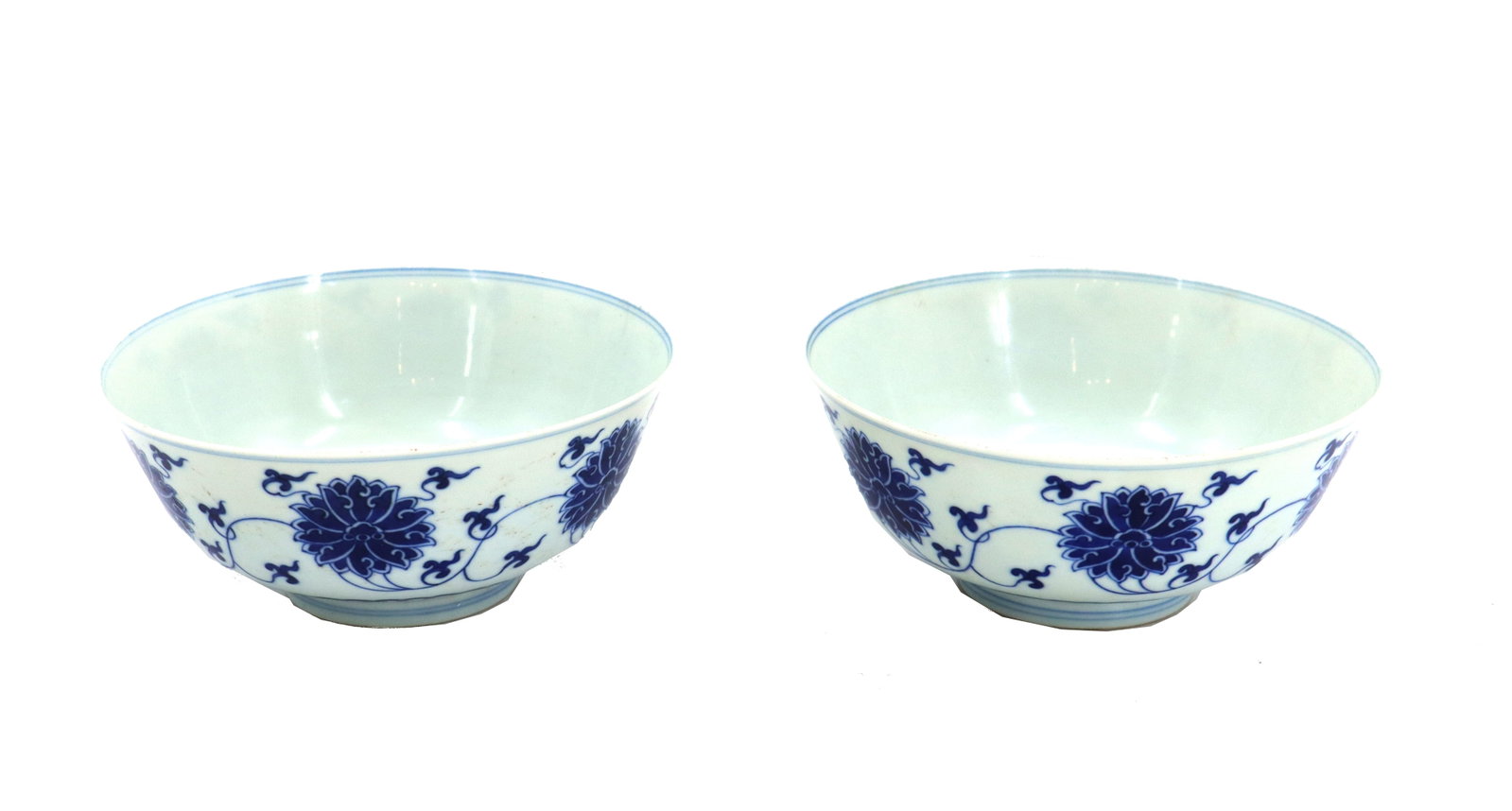 (2) Chinese Blue and White Porcelain Bowls: (2) Chinese Blue and White Porcelain Bowls. Pair of Chinese porcelain bowls with cobalt floral decoration on white, on raised circular foot. With Guangxu mark on base. Size: 3 x 6 3/4 x 6 3/4 in. Chin