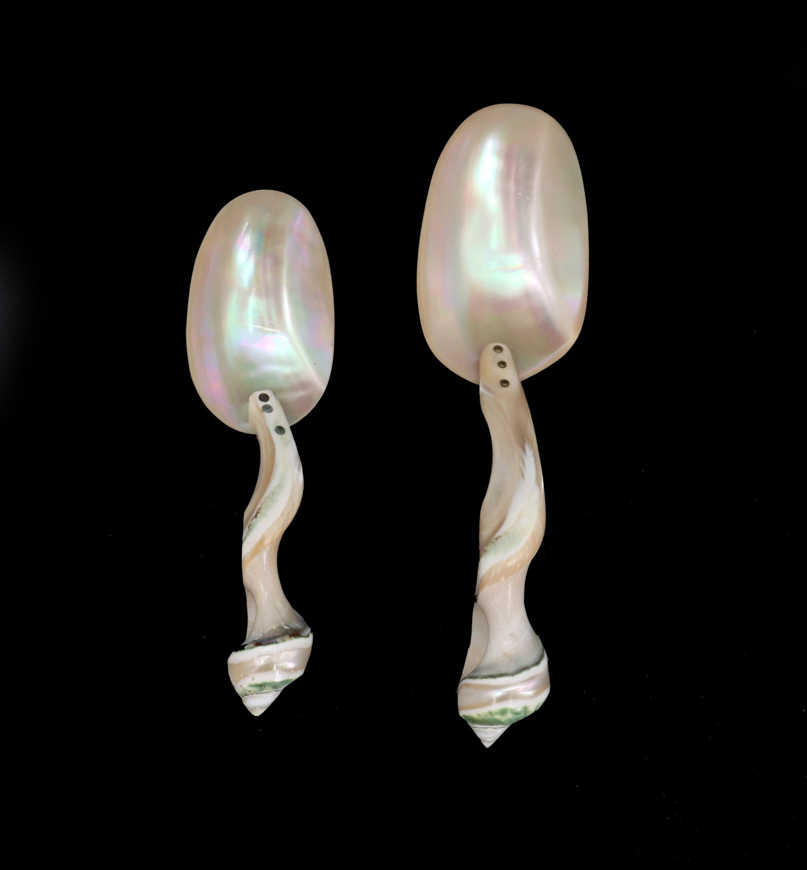 (2) Mother of Pearl Shell Caviar Spoons: (2) Mother of Pearl Shell Caviar Spoons. Delicately crafted twisting handles attached to the shell spoon heads with brass nails and backs. Size: 7 1/4 x 2 1/8 x 1 1/2 in. 