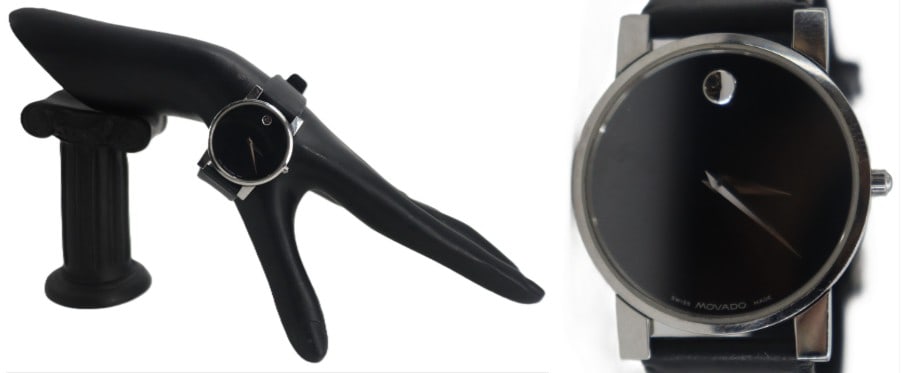 Movado Silver Toned Wristwatch: Movado Silver Toned Wristwatch. Black face. Original black leather band. Stainless steel. Water resistant. Sapphire crystal. Swiss made. Works. New battery. Watch Size: 1 1/8 x 2 1/2