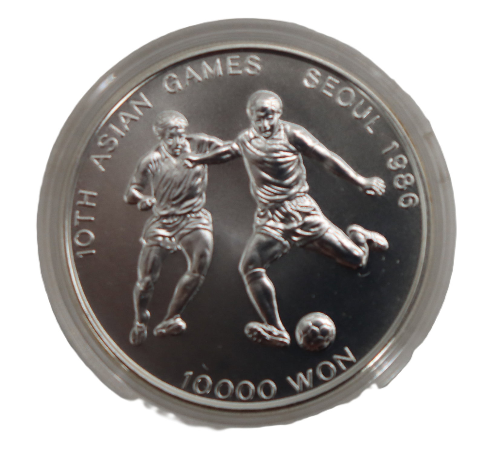 Korean Silver Commemorative Coin - Gross 0.890 ozt.: Korean Silver Commemorative Coin - Gross 0.890 ozt. Commemorating the 10th Asian Games in Seoul 1986. Depicts two football (soccer) players in the midst of playing, with the words "10000 won"