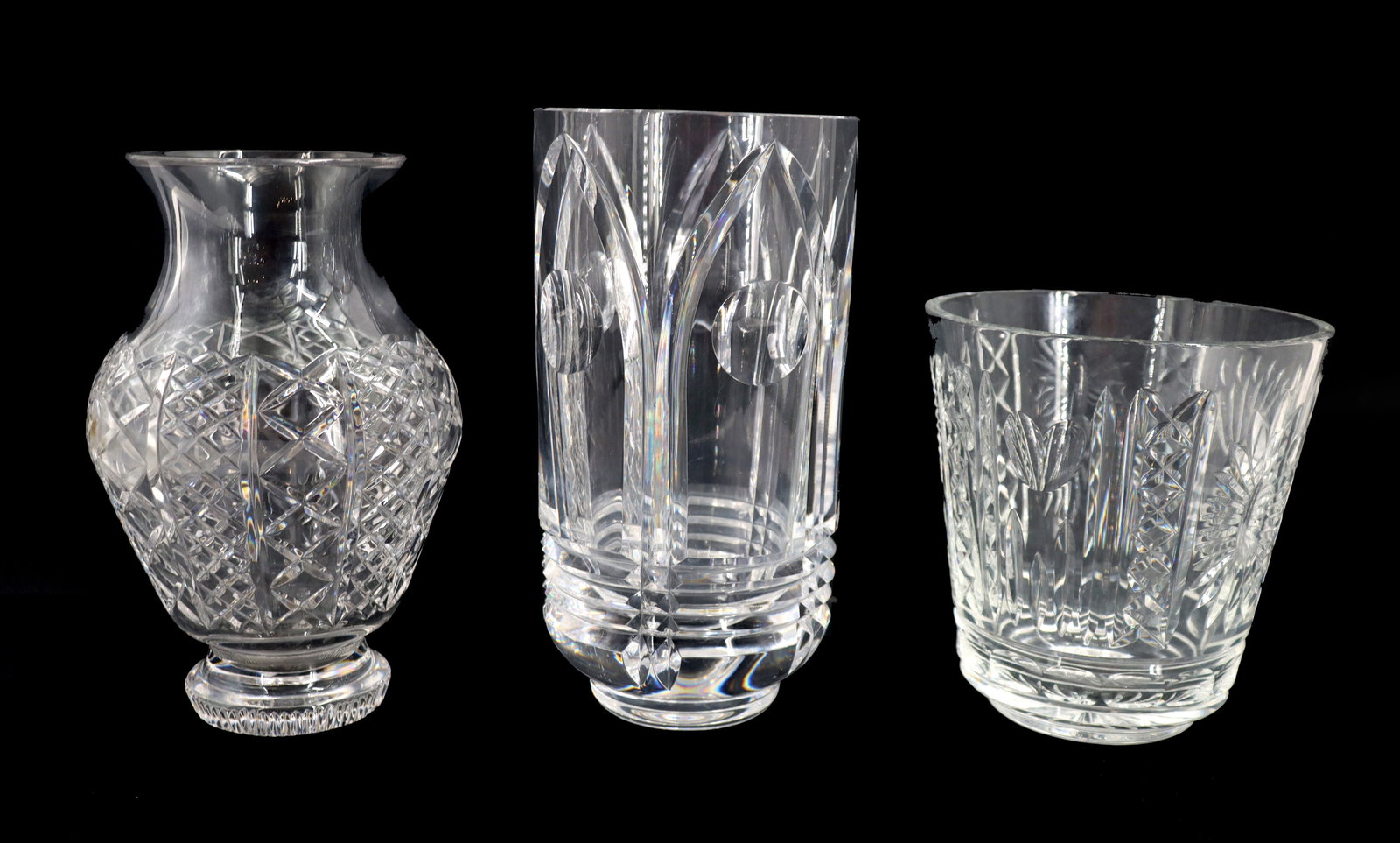 (2) Waterford and (1) Orrefors Cut Crystal Vases - AS IS: (2) Waterford and (1) Orrefors Cut Crystal Vases - AS IS. Marked on undersides. Condition: Lots of chips. Largest Size: 5 1/2 x 5 1/2 x 10 3/4 in. 