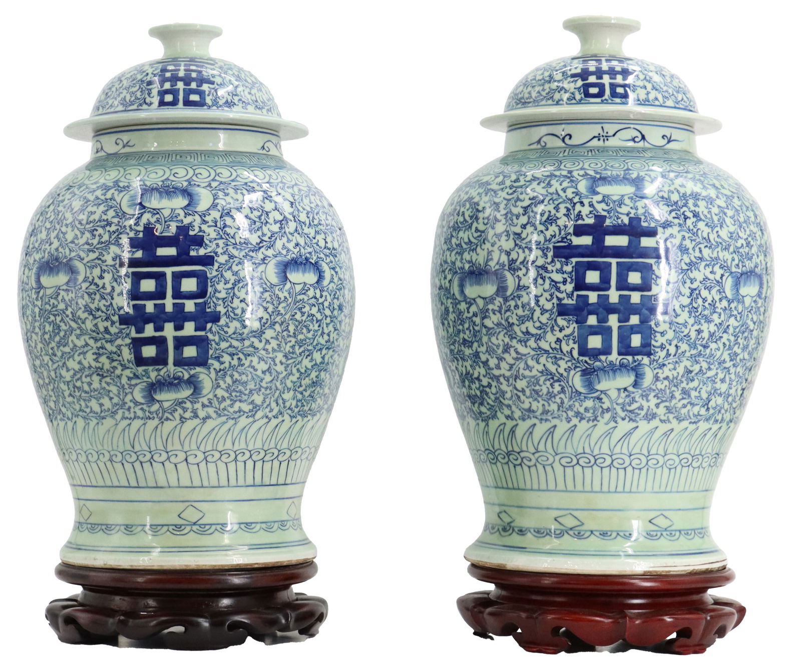 Pair of Chinese Blue and White Porcelain "Double Happiness" Jars: Pair of Chinese Blue and White Porcelain "Double Happiness" Jars. Decorated with scrolling floral and vine motif. Ovoid body that tapers toward the base. Each on carved wooden stands.&n