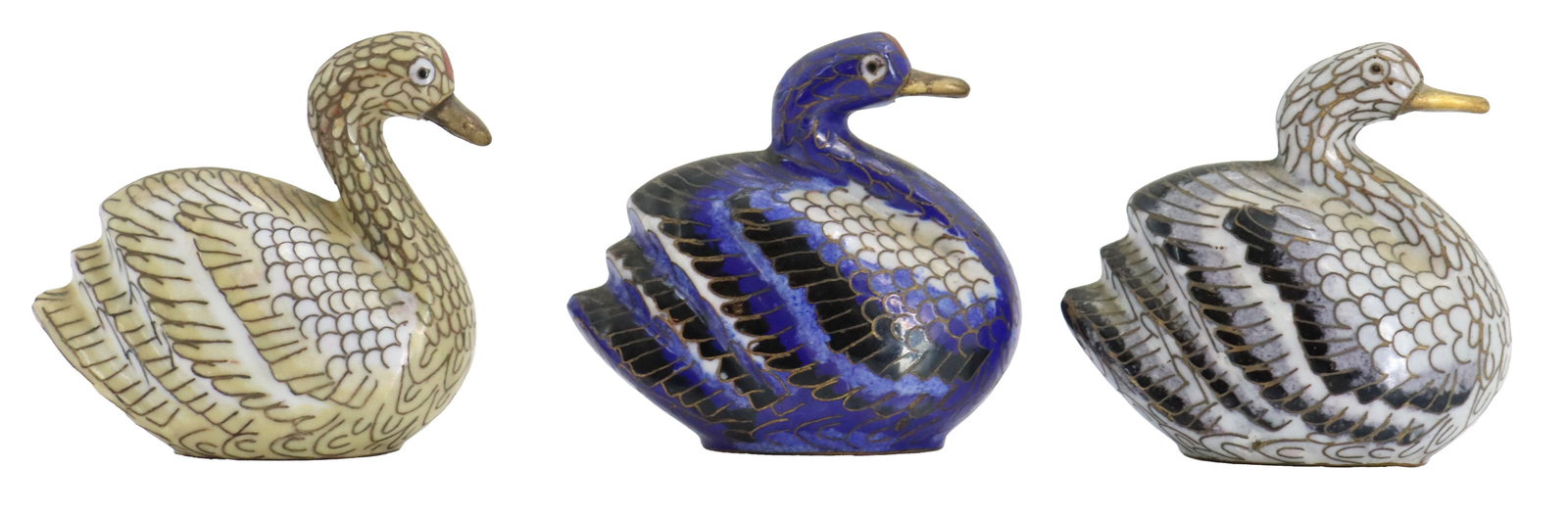 (3) Cloisonne Swan Figures: (3) Cloisonne Swan Figures. The group shows a striking variation in color scheme, featuring one swan in shades of ivory and beige, a central one in vibrant cobalt blue and black, and a third in m