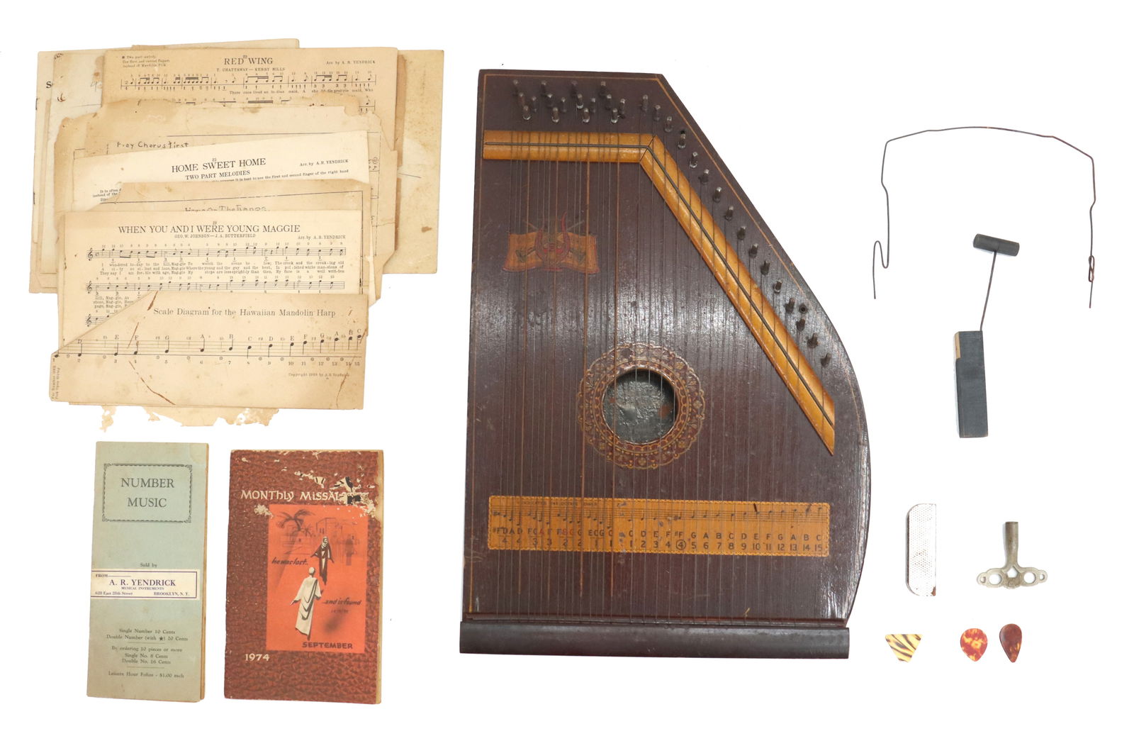 Vintage Hawaiian Mandolin Harp with Sheet Music and Accessories: Vintage Hawaiian Mandolin Harp with Sheet Music and Accessories. Including tuning key, picks, and other accessories along with many pieces of sheet music and informative pamphlets, one dated 1974. Har