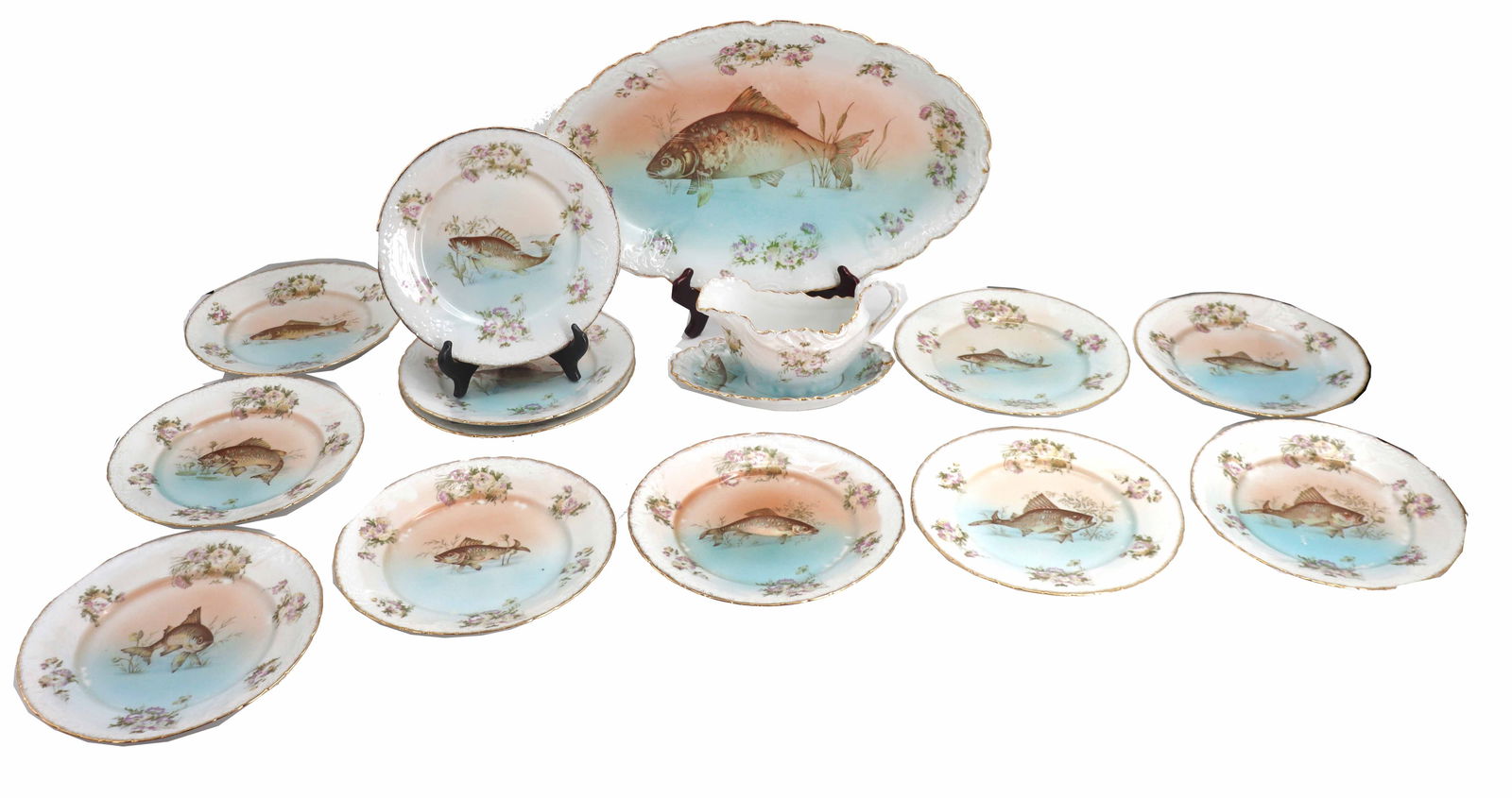 (14) Piece Antique Austrian Porcelain Fish Motif Dinnerware Set: (14) Piece Antique Austrian Porcelain Fish Motif Dinnerware Set. Includes 11 dinner plates with various fish designs on them, a gravy boat and saucer, and a large serving tray. All marked "Austri